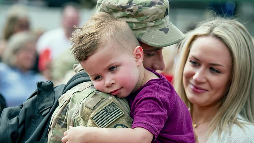 Photo of a soldier holding his little boy